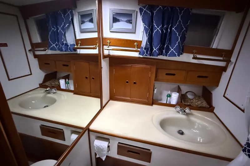 Slide: The Image of Bathroom interior of 1991 Grand Banks 42 Classic yacht with wooden cabinets and dual sinks. - 74