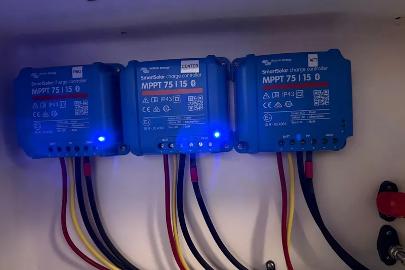 Slide: The Image of Three Victron Energy SmartSolar charge controllers in a 1991 Grand Banks 42 Classic boat. - 99