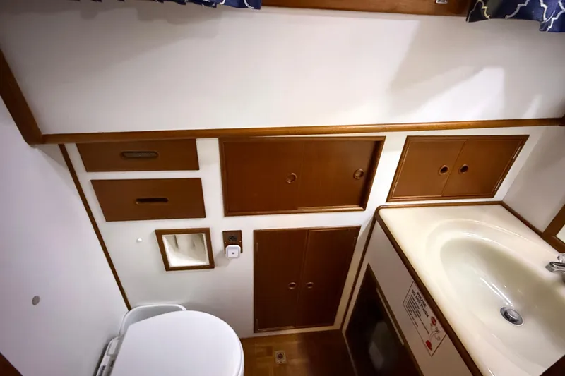 Slide: The Image of Bathroom interior of 1991 Grand Banks 42 Classic yacht with wooden cabinets and sink. - 62