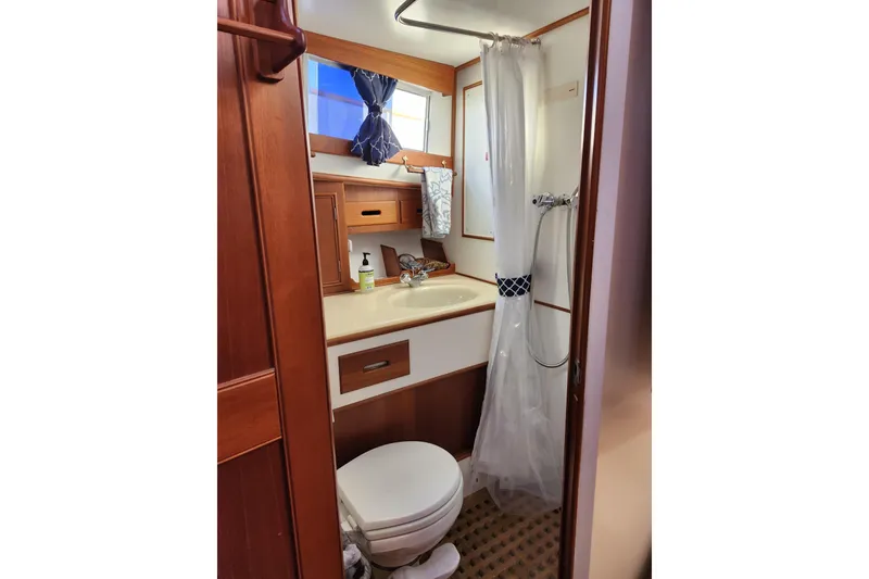 Slide: The Image of Bathroom interior of 1991 Grand Banks 42 Classic yacht, featuring shower and wooden cabinetry. - 77