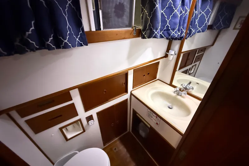 Slide: The Image of Bathroom interior of 1991 Grand Banks 42 Classic yacht with sink and wooden cabinetry. - 61