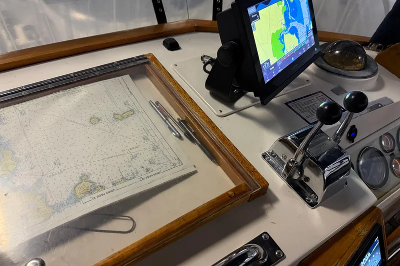Slide: The Image of Helm of 1991 Grand Banks 42 Classic with navigation chart and electronic display. - 94