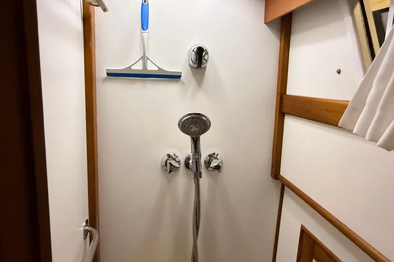 Slide: The Image of Shower area in 1991 Grand Banks 42 Classic yacht with squeegee and chrome fixtures. - 65