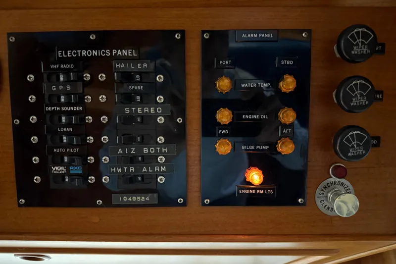 Slide: The Image of Control panel of a 1991 Grand Banks 42 Classic yacht with various switches and indicators. - 44