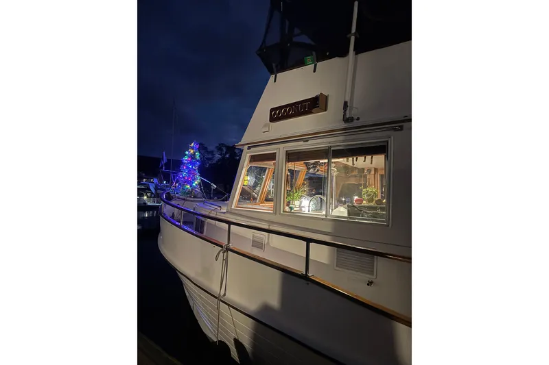 Slide: The Image of Grand Banks 42 Classic yacht, 1991 model, with festive lights and decorations at night. - 133