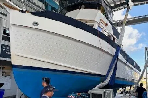 Slide: The Image of 1991 Grand Banks 42 Classic yacht in dry dock, showcasing its hull and structure. - 124