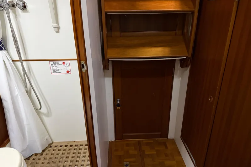 Slide: The Image of Bathroom interior of 1991 Grand Banks 42 Classic yacht with wooden cabinetry and shower area. - 102