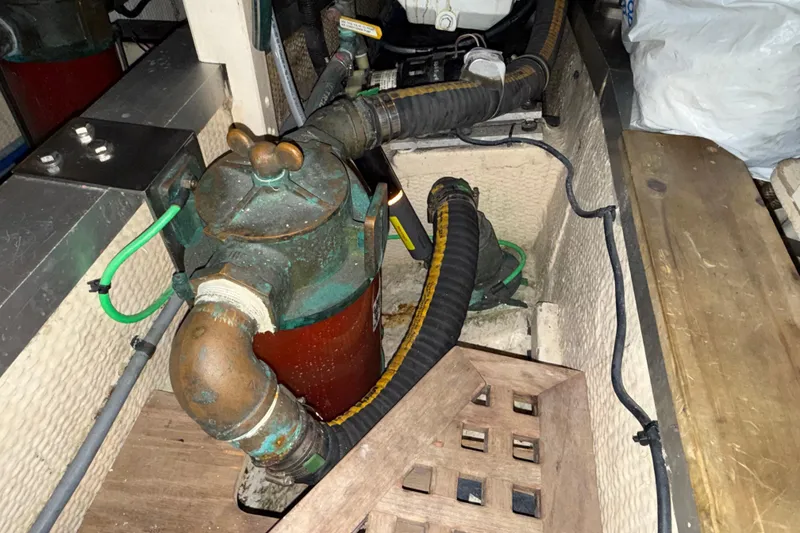 Slide: The Image of Engine compartment of a 1991 Grand Banks 42 Classic with visible hoses and components. - 112