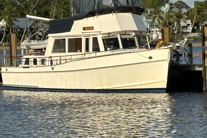 Slide: The Image of 1991 Grand Banks 42 Classic yacht docked in a serene marina setting. - 5