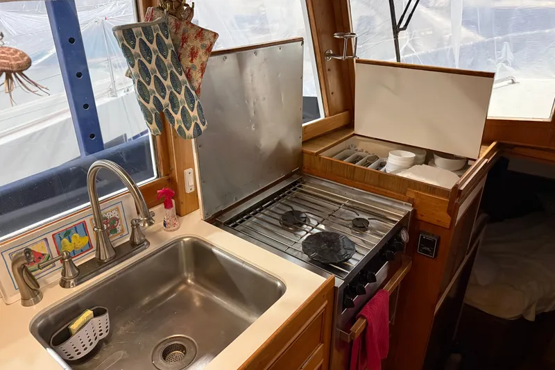 Slide: The Image of 1991 Grand Banks 42 Classic yacht kitchen with stove, sink, and utensils. - 27