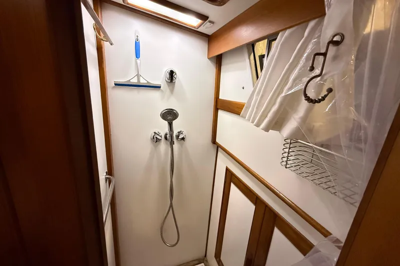 Slide: The Image of Shower area in 1991 Grand Banks 42 Classic yacht with wooden accents and modern fixtures. - 64