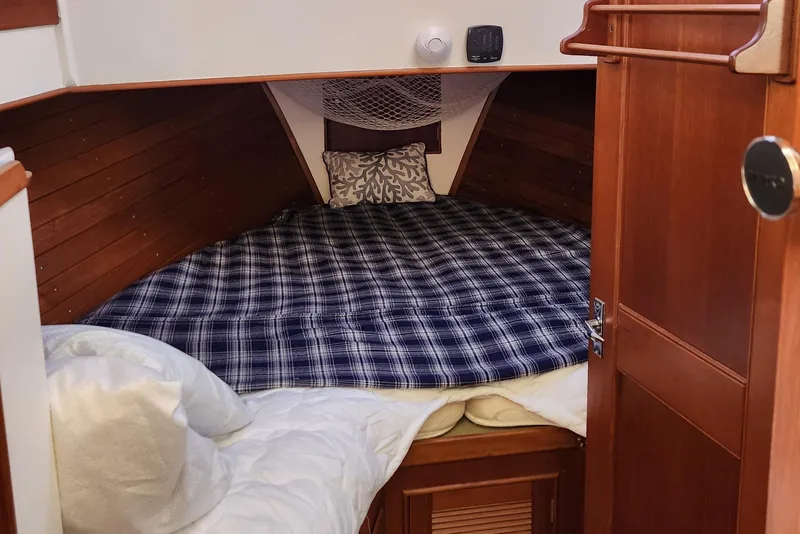 Slide: The Image of Cozy cabin interior of 1991 Grand Banks 42 Classic with plaid bedding and wooden accents. - 72