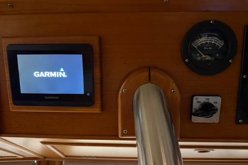 Slide: The Image of Garmin display and gauges on 1991 Grand Banks 42 Classic yacht dashboard. - 46