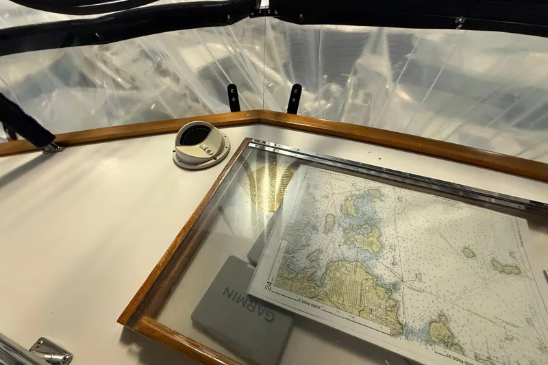 Slide: The Image of Nautical chart and compass on 1991 Grand Banks 42 Classic boat's navigation station. - 93