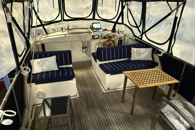 Slide: The Image of Interior of a 1991 Grand Banks 42 Classic yacht with seating and a wooden table. - 78