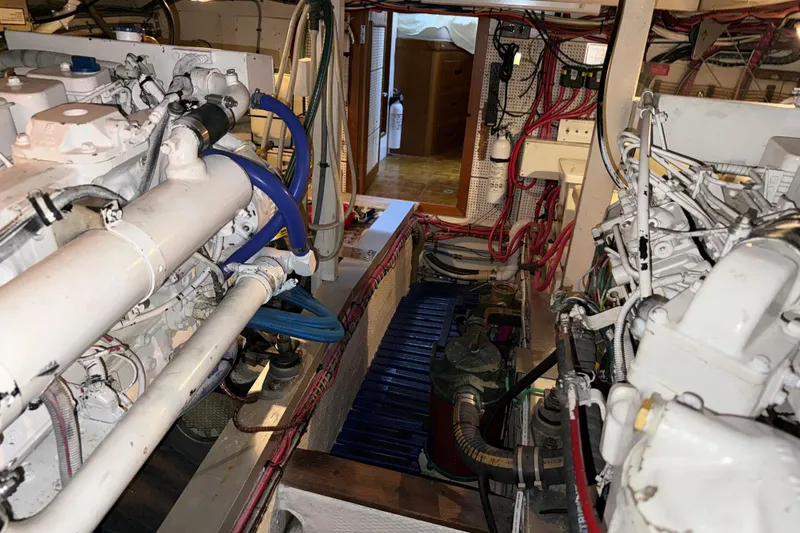Slide: The Image of Engine room of a 1991 Grand Banks 42 Classic yacht, showcasing mechanical components. - 105