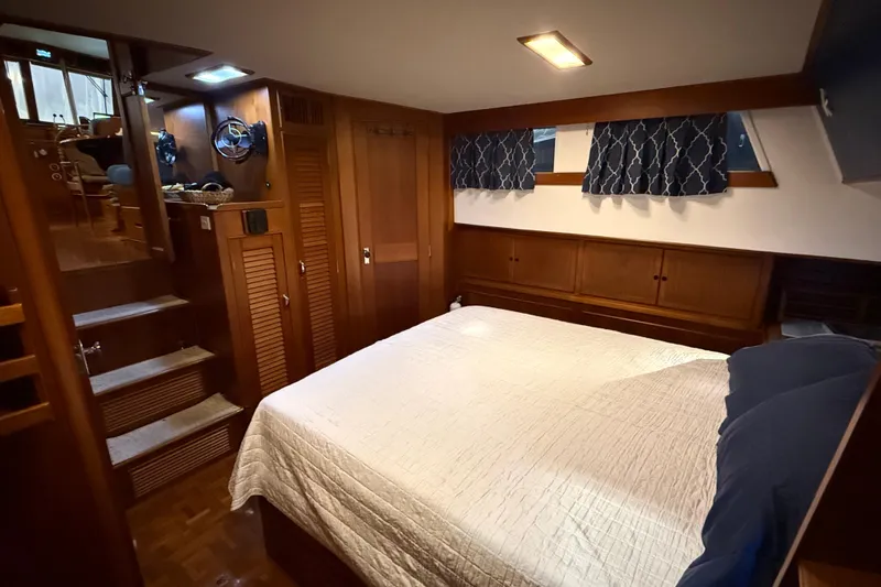 Slide: The Image of Cozy bedroom interior of 1991 Grand Banks 42 Classic yacht with wooden furnishings. - 52