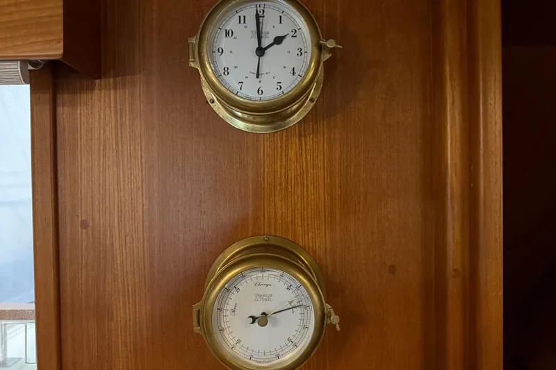 Slide: The Image of Brass clock and barometer on 1991 Grand Banks 42 Classic wooden panel. - 20