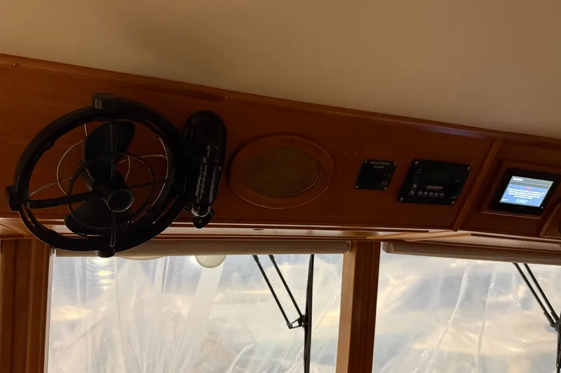 Slide: The Image of Interior view of a 1991 Grand Banks 42 Classic yacht dashboard with fan and controls. - 41