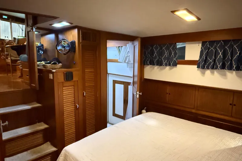 Slide: The Image of Interior of 1991 Grand Banks 42 Classic yacht, featuring cozy wooden cabin and bed. - 53