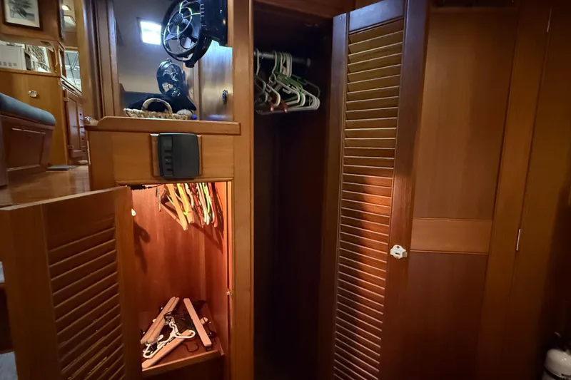 Slide: The Image of Wooden interior of 1991 Grand Banks 42 Classic yacht with open closet and hangers. - 57