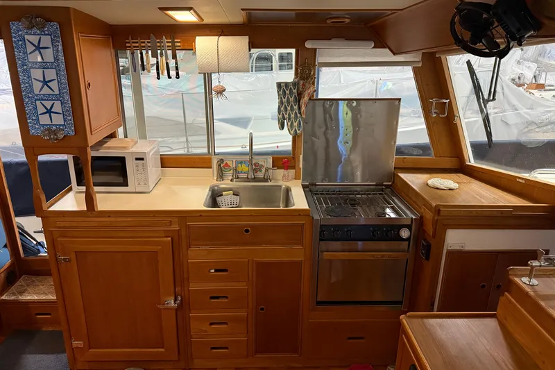 Slide: The Image of Interior of 1991 Grand Banks 42 Classic yacht kitchen with stove, sink, and microwave. - 3