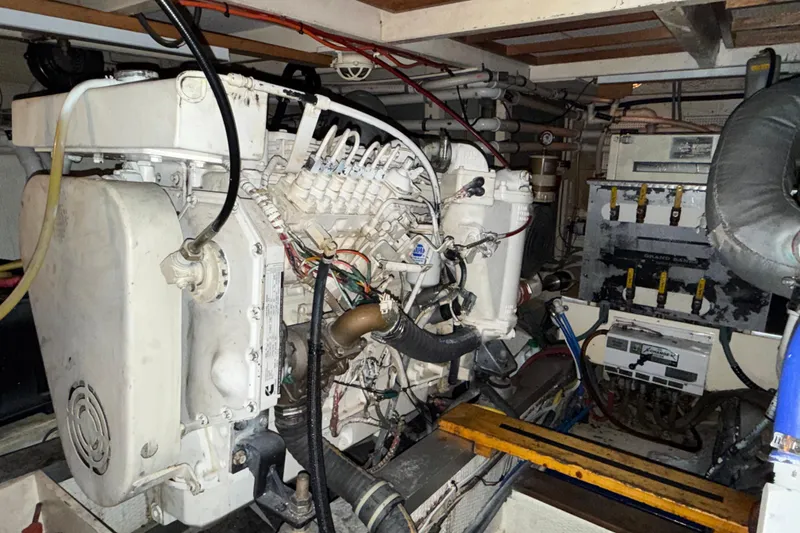 Slide: The Image of Engine room of 1991 Grand Banks 42 Classic yacht, showcasing mechanical components and wiring. - 106