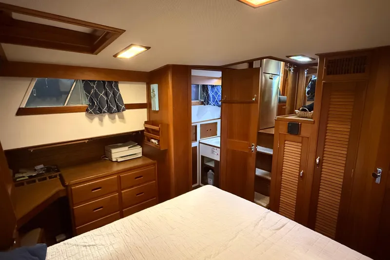 Slide: The Image of Interior of 1991 Grand Banks 42 Classic yacht, featuring wood cabinetry and cozy bedroom. - 54