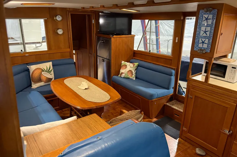 Slide: The Image of Interior of 1991 Grand Banks 42 Classic yacht with blue seating and wooden accents. - 17