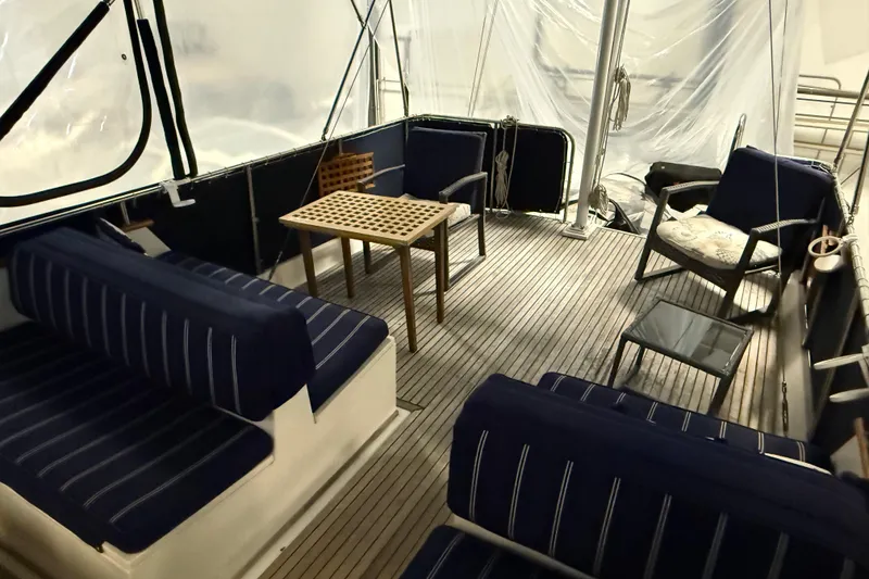 Slide: The Image of Interior of 1991 Grand Banks 42 Classic yacht with blue seating and wooden table. - 81