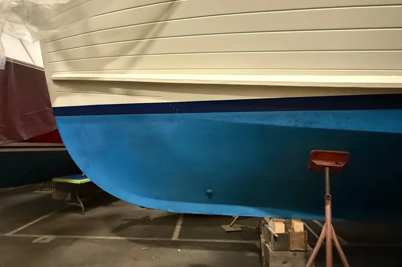 Slide: The Image of 1991 Grand Banks 42 Classic boat hull in dry dock, showcasing blue and white paint. - 125