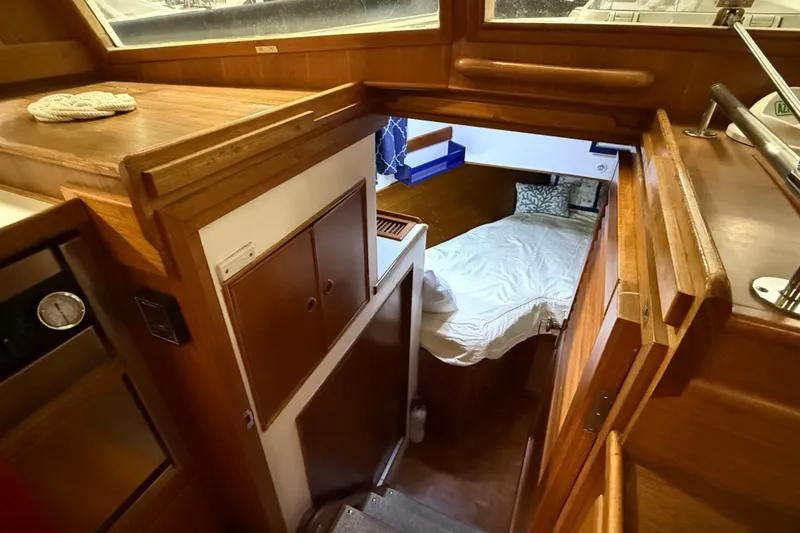 Slide: The Image of Interior of 1991 Grand Banks 42 Classic yacht, featuring cozy cabin and wooden finishes. - 66