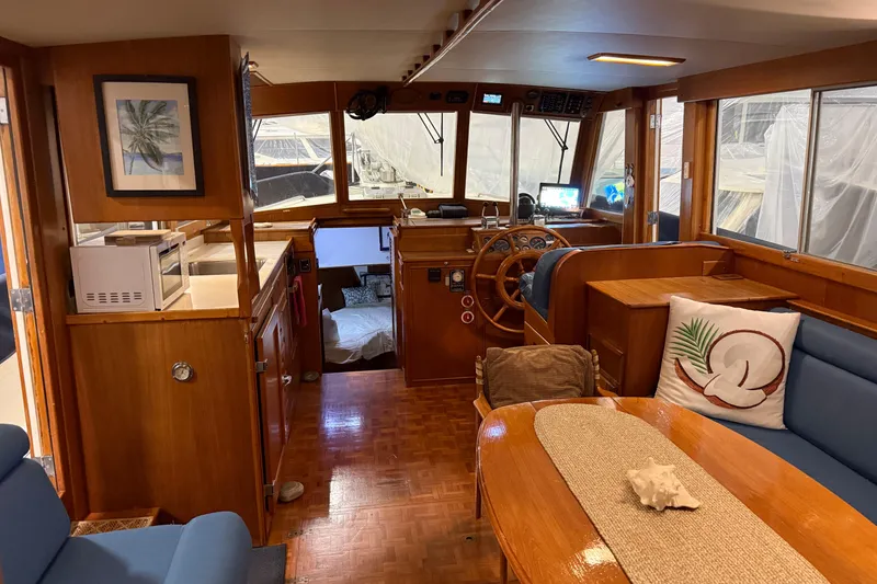 Slide: The Image of Interior of 1991 Grand Banks 42 Classic yacht with wooden furnishings and cozy seating area. - 14