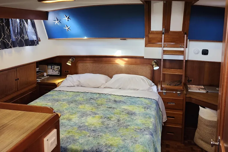 Slide: The Image of Cozy bedroom in 1991 Grand Banks 42 Classic yacht with wooden interior and nautical decor. - 60