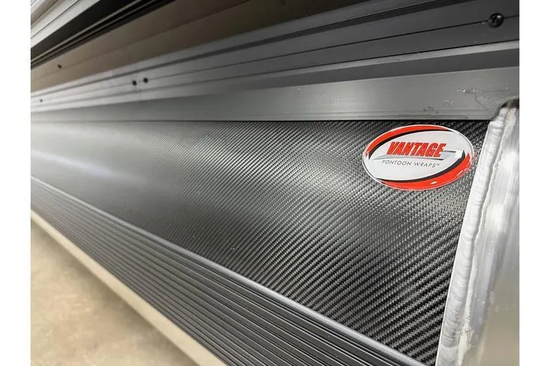Slide: The Image of Close-up of 2026 Evotti 521CS with Vantage Pontoon Wraps, featuring carbon fiber texture. - 20