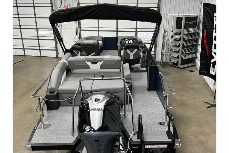 Slide: The Image of 2026 Evotti 521CS pontoon boat in showroom, featuring sleek design and powerful engine. - 21