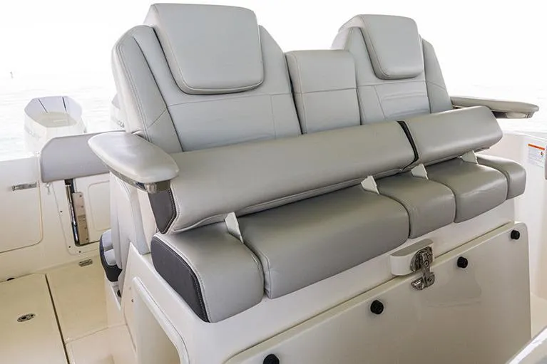 Slide: The Image of Manufacturer Provided Image: 2026 Boston Whaler 330 Outrage boat seating, featuring luxurious gray leather upholstery. - 5