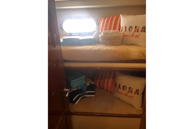 Slide: The Image of Cozy 2005 Marquis Pilothouse cabin with nautical decor and plush bedding. - 12