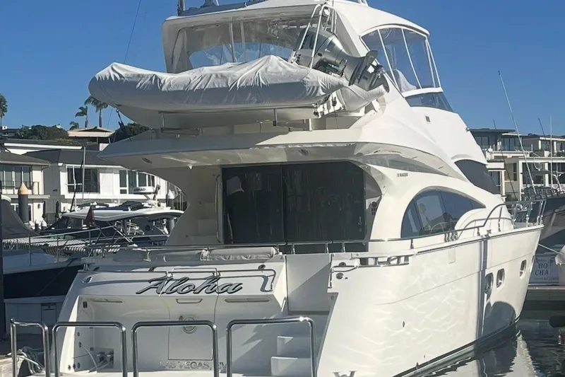 Slide: The Image of Luxury 2005 Marquis Pilothouse yacht docked at marina, featuring sleek design and spacious deck. - 16