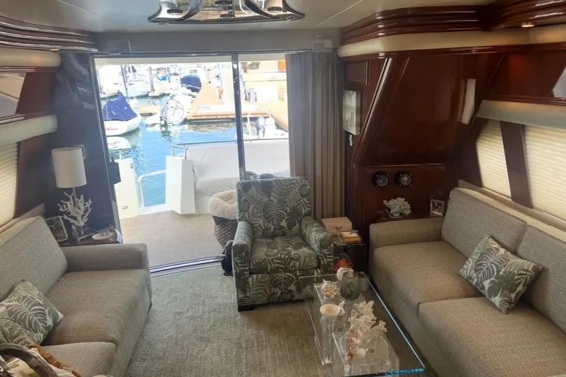 Slide: The Image of Luxurious 2005 Marquis Pilothouse yacht interior with elegant seating and marina view. - 2