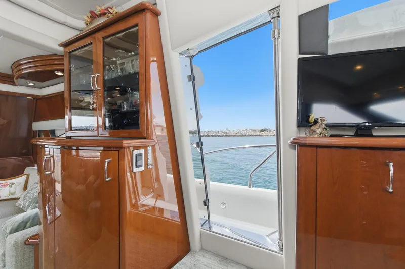 Slide: The Image of Luxurious interior of a 2005 Marquis Pilothouse yacht with elegant wood cabinetry and ocean view. - 26
