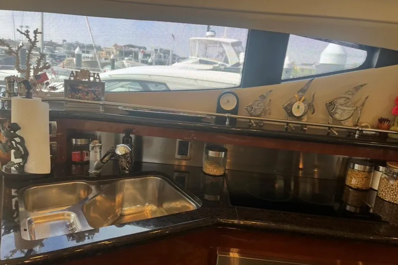 Slide: The Image of Luxurious 2005 Marquis Pilothouse yacht kitchen with modern sink and decorative elements. - 3