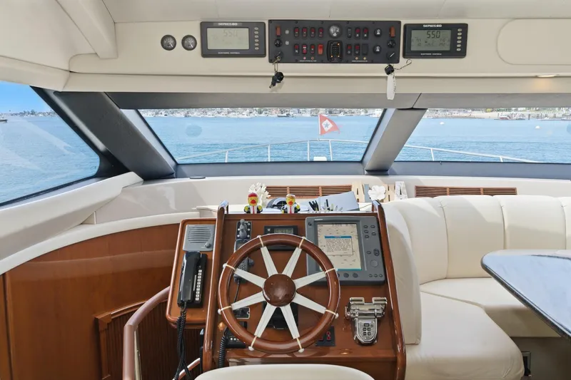 Slide: The Image of Pilothouse interior of 2005 Marquis yacht with steering wheel and navigation equipment. - 39