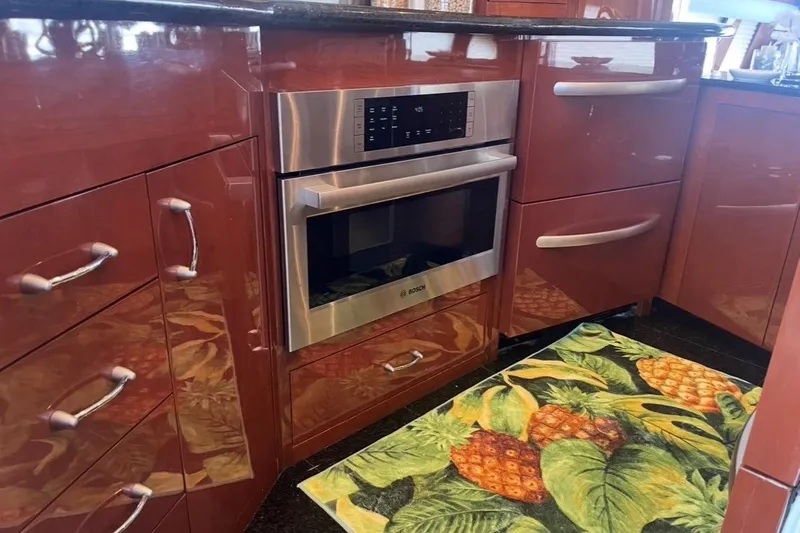 Slide: The Image of Luxurious 2005 Marquis Pilothouse kitchen with stainless steel oven and tropical-themed rug. - 4
