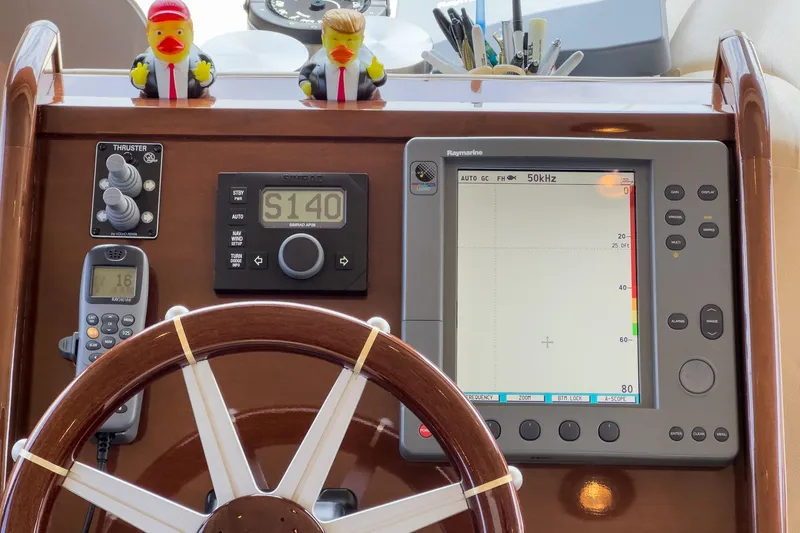 Slide: The Image of 2005 Marquis Pilothouse helm with navigation equipment and decorative rubber ducks. - 40