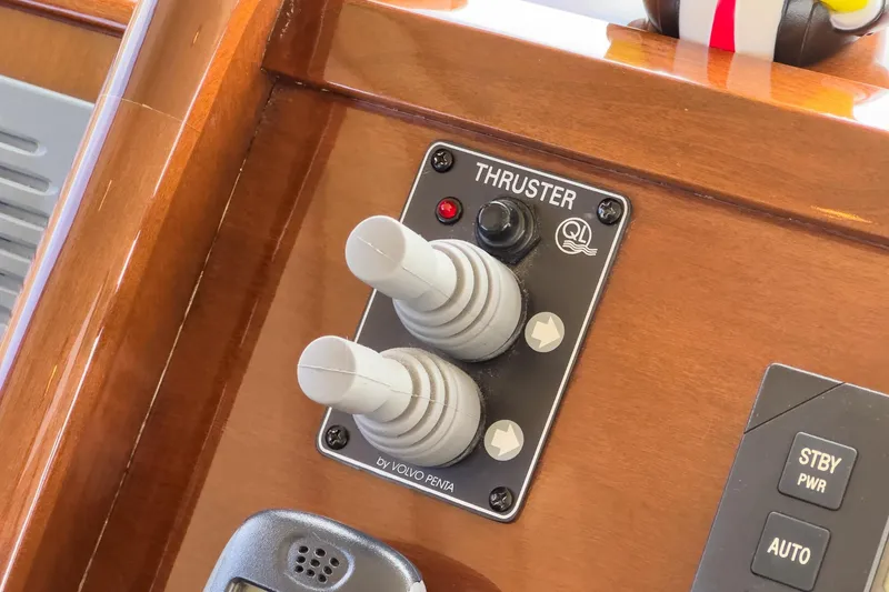 Slide: The Image of Control panel of a 2005 Marquis Pilothouse yacht featuring thruster joysticks. - 41
