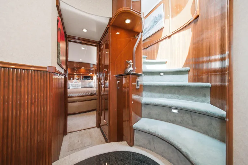 Slide: The Image of Luxurious interior of a 2005 Marquis Pilothouse yacht with elegant wood finishes and carpeted stairs. - 46