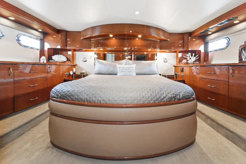 Slide: The Image of Luxurious 2005 Marquis Pilothouse yacht bedroom with elegant wood cabinetry and plush bedding. - 47