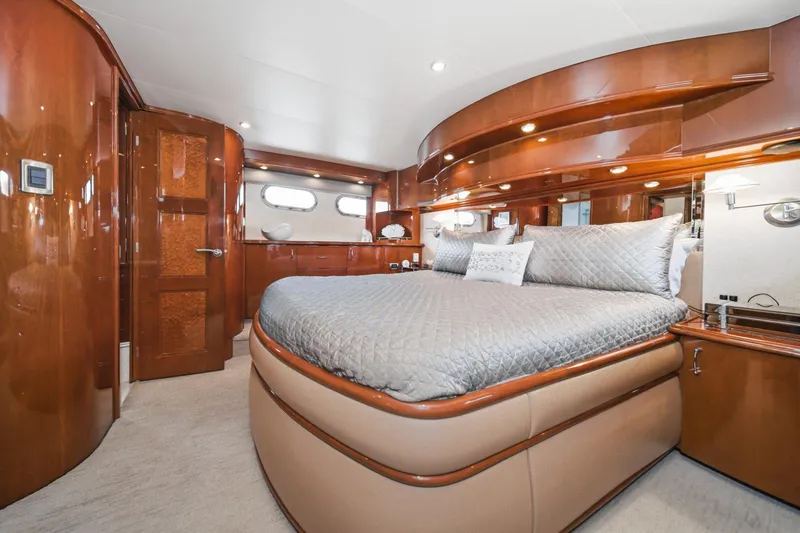 Slide: The Image of Luxurious 2005 Marquis Pilothouse yacht bedroom with elegant wood finishes and plush bedding. - 49