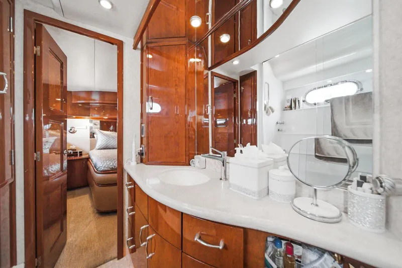 Slide: The Image of Luxurious 2005 Marquis Pilothouse yacht bathroom with elegant wood cabinetry and modern amenities. - 52